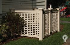 a white fence sitting next to a house