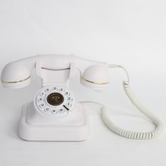 an old - fashioned white phone is on the table