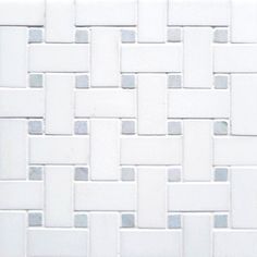 a close up view of a white tile wall