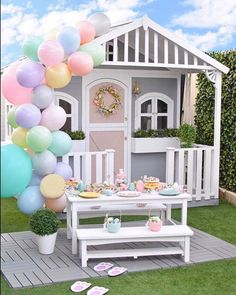 an instagram with balloons and cake on the ground in front of a small house