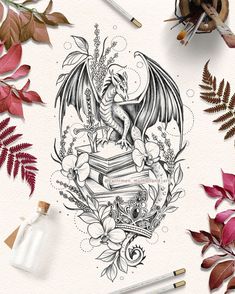 a drawing of a dragon on top of a book surrounded by leaves and other items