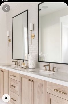 a bathroom with double sinks and two mirrors on the wall next to eachother