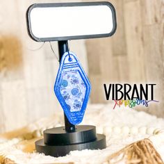 a close up of a small mirror on a stand with a white and blue background