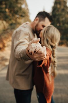 a man and woman pointing at the camera