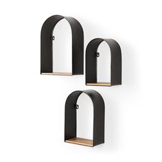 three black shelves with arched windows on them