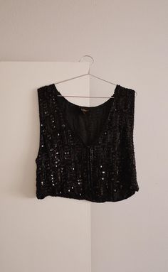 Late 70's - early 80's black silk beaded vest by Spell Bound. Such a stunning piece! Wear as a vest or as a top. Front neckline is a v-neck. Has eye hook closures on the front. Excellent vintage condition - all beading is in tact. Labeled a size medium. Made in India. Measurements Shoulder - Shoulder: 15.5" Bust: 19" Length: 19" Fitted Vintage V-neck Vest, Vintage Embellished Sleeveless Top, Vintage Sleeveless Sequin Top, Black Vintage Vest For Spring, Vintage Black Vest For Spring, Bohemian Fitted Tank Top For Party, Fitted Bohemian Tank Top For Party, Bohemian Fitted Vest For Party, Vintage Black Vest For Party