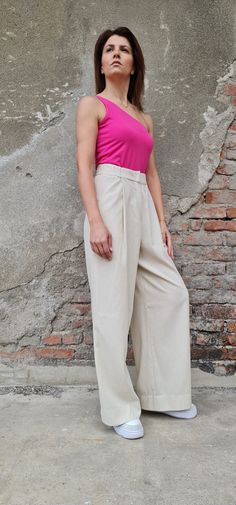 "This wide leg linen pants are perfect fit for the warm months of the year. The men style trousers has two side pockets and hook fly closer. On the back, there are two decorative pockets. ✥ Welcome to my world! I create my design in my dreams and I draw geometric lines and extravagant patterns with scissors, needles and thread. Be my dream catcher and let me create for you a parallel fashion world! ✥ SHIPPING Express shipping: 2-3 biz days via DHL Worldwide ✥ SIZING The model in the picture wear Beige Harem Pants For Work, Beige Loosely Fitted Harem Pants For Work, Linen Full-length Dress Pants For Spring, Full-length Linen Dress Pants For Spring, Beige Trousers For Summer Work, Beige Summer Work Trousers, Spring Full-length Linen Dress Pants, Beige Linen Full-length Bottoms, Beige Linen Full Length Bottoms