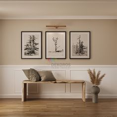 three framed pictures hang on the wall above a bench in a room with wood floors