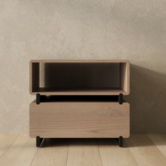 a wooden shelf sitting on top of a hard wood floor next to a white wall