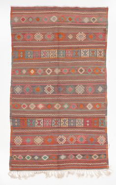 an orange and red rug with fringes on the bottom, two rows of different colors