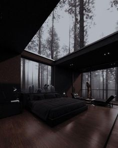 a large bed sitting in the middle of a bedroom next to a forest filled with trees