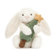 a white stuffed rabbit with a green scarf around its neck, holding a gold star