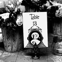 there is a table with flowers in vases and a sign that says table 13