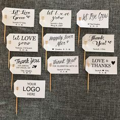 six wedding signs on sticks with the words, let love grow and thank you're here