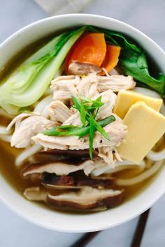 a white bowl filled with soup and vegetables