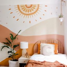 a bedroom with an orange and white wall painted on the walls, a wicker headboard