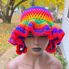 a mannequin wearing a multicolored crocheted hat on top of it's head