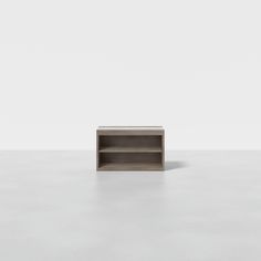 an empty shelf sitting on top of a white floor