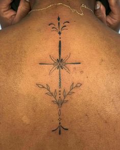 a person with a cross tattoo on their back