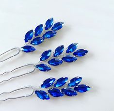 Upgrade your hairstyle with our Set of Three Royal Blue Crystal Hair Pins. This set includes three hairpins adorned with beautiful royal blue crystals that shimmer with elegance. Whether you're dressing up for a special occasion or just want to add some glimmer to your everyday look, these hairpins effortlessly enhance your style with their enchanting sparkle. Each hairpin features brilliant royal blue crystals, adding a touch of charm and sophistication to your hair. Use this versatile set of t Blue Headpiece, Blue Hair Pins, Crystal Hair Pins, Pearl Accessories, Handmade Headbands, Crystal Hair, Your Hairstyle, Shop Gifts, Blue Crystals