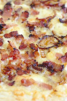 a pizza with bacon and cheese on it