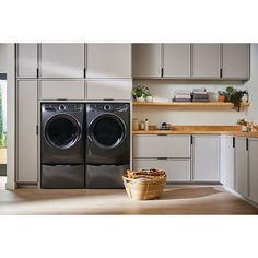 a washer and dryer sitting in a kitchen next to each other on top of a hard wood floor