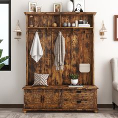 an old wooden cabinet with towels hanging on it