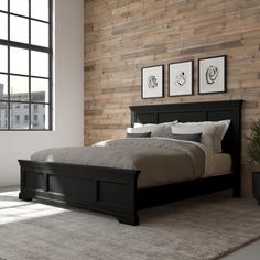 a bedroom with wood paneled walls and a bed in the middle, along with a rug on the floor