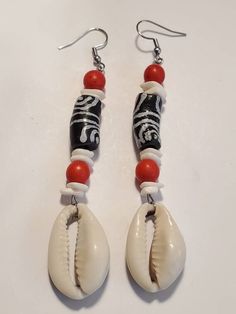 Check out this item in my Etsy shop https://www.etsy.com/listing/1022248552/black-white-ghana-krobo-cowrie-shell Bohemian White Earrings With Black Beads, White Dangle Jewelry With Black Beads, Black Beach Jewelry With Dangling Beads, Beach Jewelry With Black Dangling Beads, Black Dangling Beads Jewelry For Beach, White Drop Earrings With Black Beads, White Bohemian Beaded Earrings With Black Beads, Black Beaded Drop Earrings With Large Beads, Black Large Beaded Drop Earrings