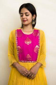 Mango and pink tunic with front gathered work and zari and sequins hand embroidered yoke. Comes with trousers and a slip.
Components: 3
Pattern: Hand embroidered
Type Of Work: Zari, Sequins
Neckline: Round
Sleeve Type: Kurta : Three quarter, Slip : Sleeveless
Fabric: Mul chanderi, Lining : Mulmul
Color: Yellow
Other Details: 
Closure : Back button
Disclaimer : The natural imperfection and textures in the weaves are the outcome of handloom fabrics (not to be considered as defect)
Occasion: Mehend Handloom Fabric, Pink Tunic, Embroidered Tunic, Fashion App, Pant Set, Embroidery Details, Pink Fabric, Set For Women, Aza Fashion