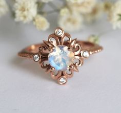 Beautiful vintage inspired moonstone and diamond ring. Available in 14 and 18k gold, platinum. Other stones are also available: morganite, pearl, turquoise, diamond, rose cut diamond, black diamond, aquamarine and many more. Please contact us for the pricing info. Click here for moissanite ring: https://www.etsy.com/listing/475034416/vintage-moissanite-ring-gold-engagement?ref=shop_home_active_3 Please choose ring size and metal at the drop down menu. Larger sizes than 8 available upon request. Rose Gold Moonstone Ring With Rose Cut Diamonds, Unique Moonstone Ring With Rose Cut Diamonds For Wedding, Unique Moonstone Ring With Rose Cut Diamonds For Anniversary, Unique Wedding Moonstone Ring With Gemstone Accents, Elegant Rose Gold Moonstone Ring, Unique Moonstone Ring With Rose Cut Diamonds, Unique Moonstone Ring With Rose Cut Diamonds As Gift, Elegant Rose Gold Moonstone Ring With Rose Cut Diamonds, Round Moonstone Ring With Diamond Accents As Gift