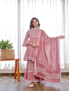 Take your fashion game to the next level with this Pheeta set of pink printed flare peplum with double flare sleeves, contrasting print yoke, crochet lace combined with two tired shararas, and printed cotton dupatta. Neck: Mandarin Collar Sleeve Length: 3/4th Flared Sleeves Kurta Length: Above Knee Fabric: Kurta & Bottom - Cotton Dupatta - Cotton Note: Wash Care Instructions - Dry Clean Only. The product will be shipped within 15-20 days of the order placed Measurements: Size Bust Waist Hip XS 3 Peplum Sharara, Printed Sharara, Printed Peplum Top, Floral Work, Sequin Blouse, Cotton Dupatta, Flare Sleeves, Sharara Set, Indian Fashion Designers