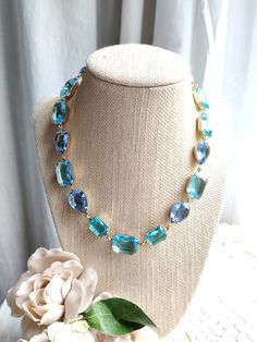 "Mixed shape collet necklace created with vintage swarovski crystals in aquamarine and pale sapphire blue. I wonderful mix of pear and octagon shapes and very soothing colors to wear to the office or an evening out...why not even with your favorite jean jacket? The settings are lacquered brass in gold, with custom artisan created findings. It's 16\" with a 2\" extender. This necklace is lovely for environmentally conscious women. All of the rhinestones are old stock swarovski and Czech glass, fr Light Blue Necklace, Peach Necklace, Clear Necklace, Green Statement Necklace, Peridot Color, Good Jewelry, Blue Statement Necklace, 2023 Wishlist, Edwardian Jewelry