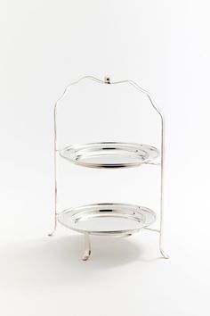 two tiered serving trays with metal handles on each side, one holding an empty plate