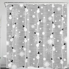 a shower curtain with snowmen and stars on the curtains is shown in black and white