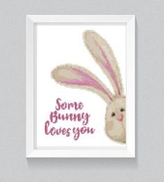 a cross stitch bunny with the words some bunny loves you on it's face