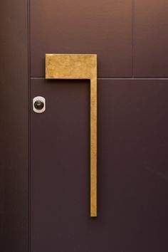 a door handle on the side of a brown door