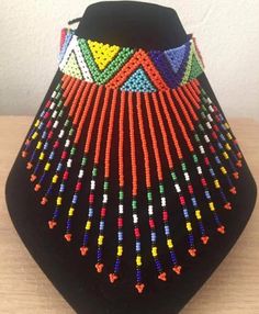 This beaded Zulu Necklace has been handcrafted by Zulu women in South Africa and has become famous around the world. We have various colours such as Blue, red, black and white, Yellow. Traditional Multicolor Beaded Necklaces As Gift, Traditional Handmade Multicolor Beads, Traditional Handmade Multicolor Beaded Necklaces, White Beaded Choker For Festivals, Artisan Multicolor Beaded Necklace, Red Traditional Beads For Crafting, Traditional Red Beads For Crafting, Traditional Multicolor Necklace With Black Beads, Artisan Multicolor Beaded Necklaces For Festivals