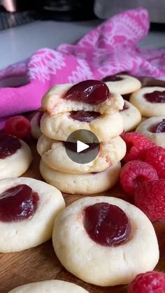 raspberry shortbread cookies are arranged on a cutting board