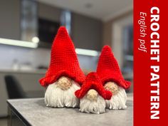 two crocheted gnomes sitting on top of a counter