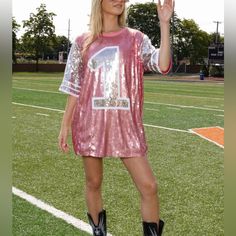 Be The Of The Game In This Sparkly Oversized T-Shirt Dress!! You’ll Look Like The # 1 Fan At The Party Wearing This Sequin Jersey Featuring “1�” On The Front And Stars On The Sleeves. Add Some Fun And Sparkle To Your Game Day Outfit With This Pink Sports Jersey - Sequin Tee Shirt Dress - Pink And Silver Sequins - Short Sleeve - Crew Neckline - Lined - Perfect Game Day Dress Or Oversized Tee - Fabric: Shell (100% Polyester) Contrast (60% Polyester, 35% Cotton, 5% Spandex) Approximate Measurements Sequin Tee Shirt, Sequin Jersey, Game Day Dress, Giraffe Print Dress, Sequin Pink, Barbie Pink Dress, Pink Jersey, Gameday Dress, Oversized T Shirt Dress