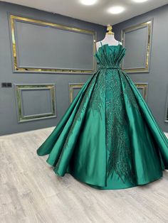 a green ball gown on display in a room