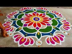 a woman is sitting on the ground with her feet propped up in front of a colorful rang