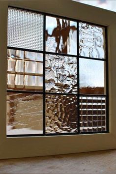 an image of a window that is reflecting the sky and water in it's reflection