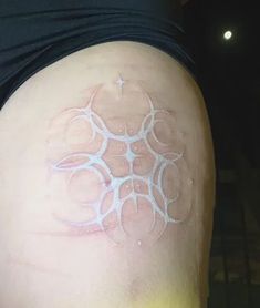 a person with a tattoo on their back that has circles and stars painted on it