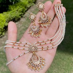 Featured is an all pearl jadau necklace set in 22k gold. The necklace can be worn both as a choker as well as a short necklace with tassle adjustment. The necklace weighs 30.40 gms including 17.71 gms in the stringing and hanging pearl beads The earrings weigh 11.65 gms including 1.17 gms in the hanging pearls. Price Breakup Summary Component Rupees % of Total 22k Gold 120,075 74.0% Stones & Beads 15,925 9.8% Making Charges 21,614 13.3% Taxes (GST) 4,728 2.9% Total 162,343 100.0% View Detailed B Jadau Necklace Set, Pearl Choker Set, 22k Gold Jewelry Necklaces, Jadau Necklace, Pearl Mala, 22k Gold Jewelry, Buy Pearls, Pearl Necklace Set, Gold Jewelry Necklace