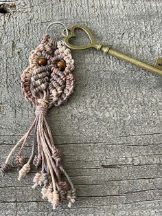 a crocheted keychain hanging from a metal hook