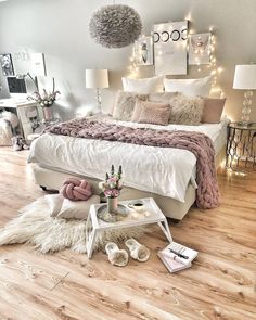 a white bed sitting on top of a wooden floor