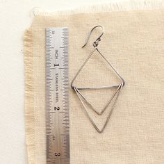 "Unique earrings made of three connected triangles of forged oxidized silver. Measure 2 1/4\". Handmade shepherd hook earwires. Sterling silver, which has been oxidized and hand polished for an antique finish. Your jewelry will arrive beautifully gift wrapped in a small box tied. If this is a gift being shipped directly to the recipient, please let me know. I will be glad to include a note from you. Want to see more of my work? Click here to return to my etsy shop: http://www.etsy.com/shop/SDJew Silver Triangle Jewelry With Ear Wire, Everyday Triangle Nickel-free Jewelry, Everyday Nickel-free Triangle Jewelry, Nickel Free Triangle Metal Earrings, Nickel-free Metal Triangle Earrings, Modern Hoop Earrings, Shepherds Hook, Triangle Earrings, Oxidized Silver