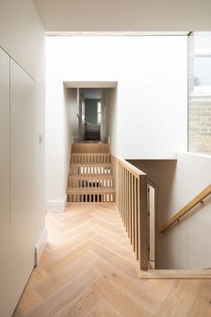 an empty room with wooden stairs and white walls